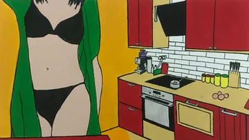 Woman in black bikini in kitchen with red cabinets.