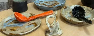 Ceramic plates and spoons on a table.