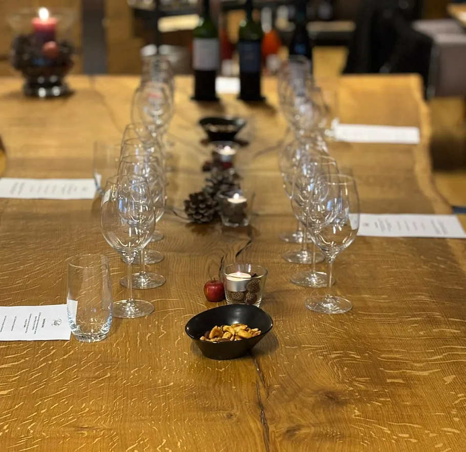 Table set with wine glasses and decorative candle.