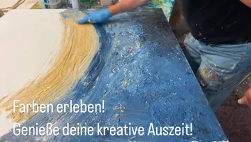 Person painting abstract art on canvas.