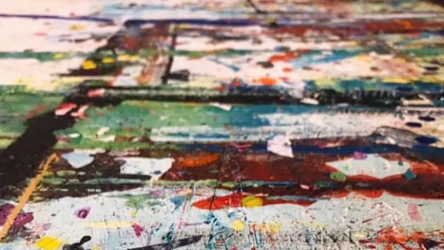 Colorful paint splatter on surface with text overlay.