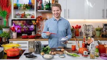 Man holding bowl and chopsticks in kitchen