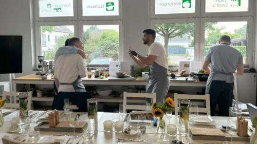 Three men cooking in a kitchen workshop.