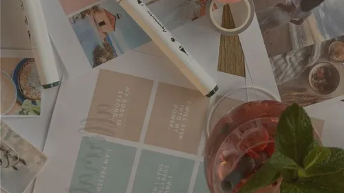 Craft materials with motivational phrases and drink.