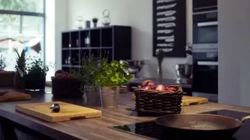 Modern kitchen with herbs and baskets.