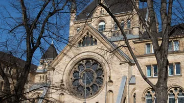 Historical building with large circular window.