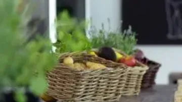 Baskets filled with vegetables on a table.