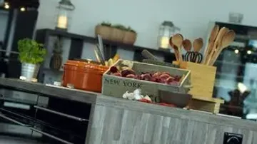 Kitchen counter with herbs and utensils.