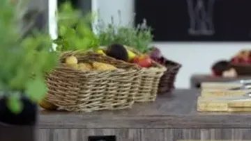 Wicker baskets with fruits on table.