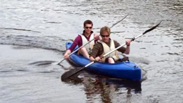 Two people kayaking on a lake.