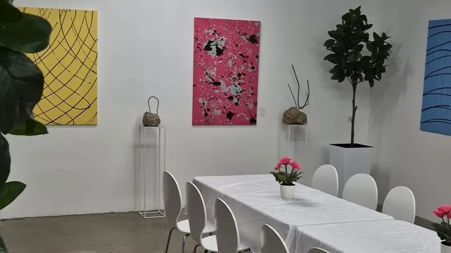Modern gallery with vibrant abstract paintings.