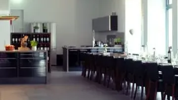 Modern kitchen with long dining table.