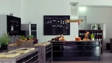 Modern kitchen with chalkboard cow diagram.
