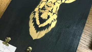 Lion-art-burned-on-black-wood-board