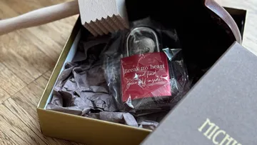 Box with lock, mallet, and note inside.