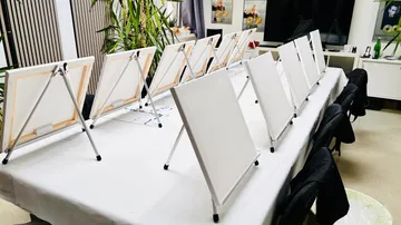 White canvases on easels in art studio.