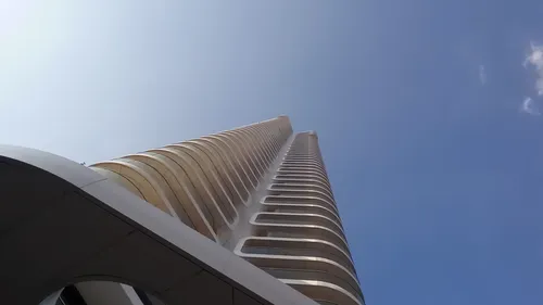 High tower stretches out against the blue sky.