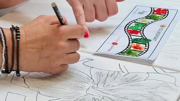 Hand drawing floral design with pencil guidance.