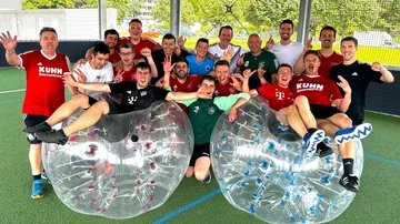 Group of people smiling with clear bubble balls.