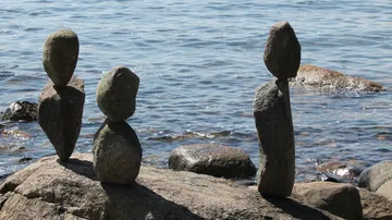 Balanced rocks on a lakeshore.