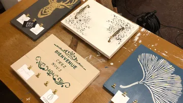 Decorative signs with hooks on table.