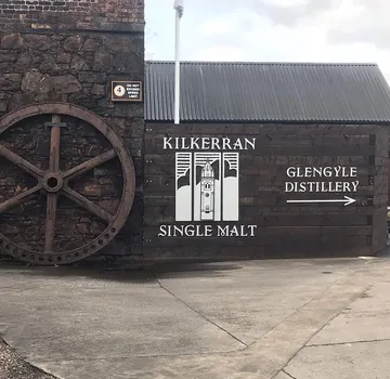 Large wheel and signs for Kilkerran Single Malt and Glengyle Distillery.