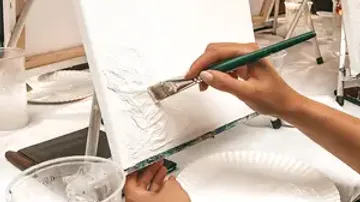 Hand painting on canvas with brush.