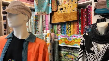 Mannequins display clothes in fabric store.