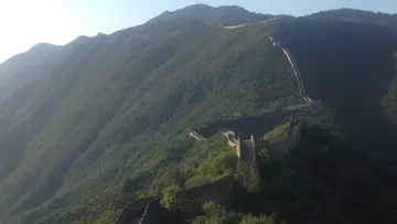 Great Wall winding over lush hills.
