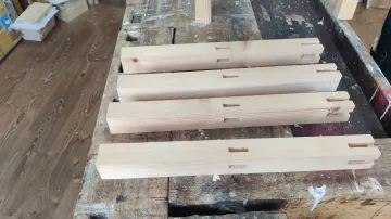 Wooden beams on a workshop bench.