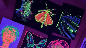 Neonkunstwerke unter Schwarzlichtlühen.