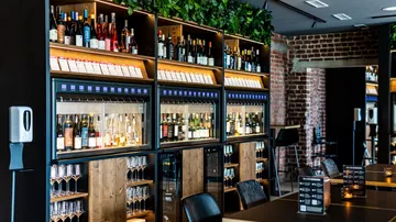 Wine dispensers in a modern bar setting.