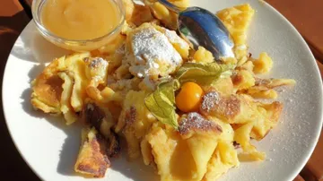 Kaiserschmarrn dessert with applesauce on a plate.