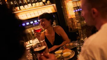 People enjoying wine in a cozy bar.