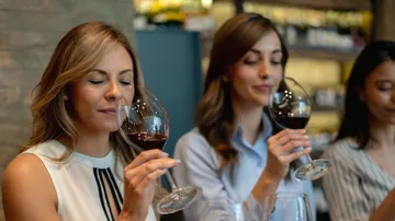 2 women trying wine