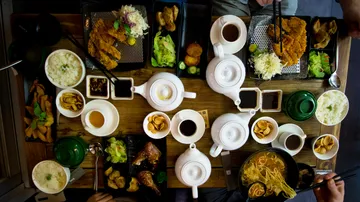 Table with diverse Asian-style food dishes.