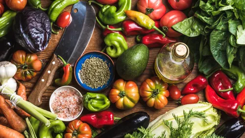 Various fresh vegetables with spices on table.