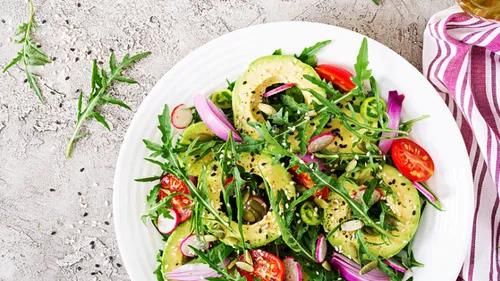 Avocado salad with greens and cherry tomatoes.