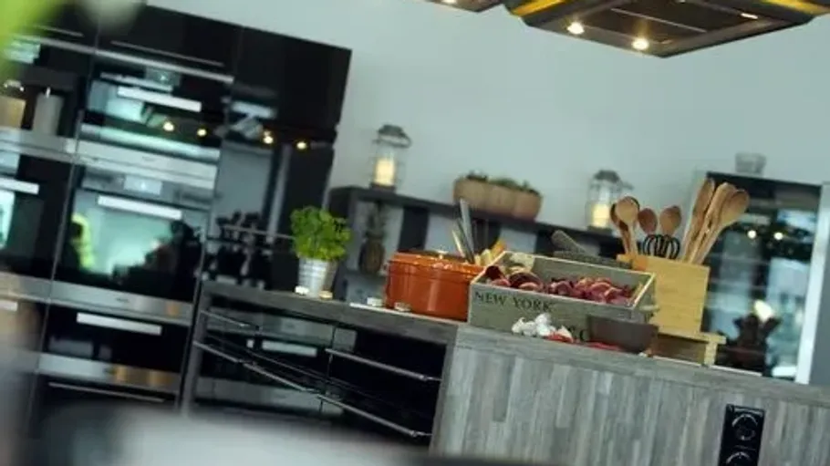 Modern kitchen with island and utensils.