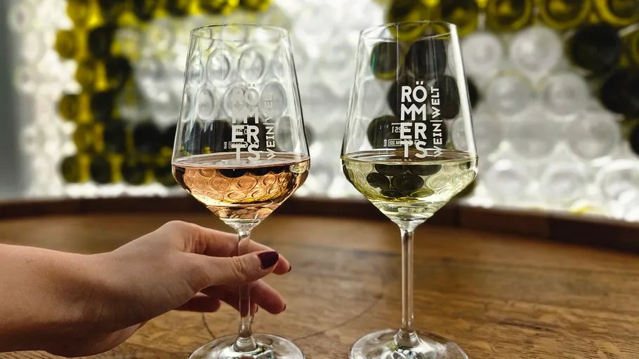 Two wine glasses on a wooden surface.