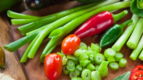 Fresh vegetables on wooden cutting board.