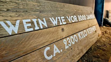 Wooden sign with German text in cellar.