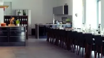 Modern kitchen with long dining table.