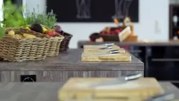 Cutting boards and baskets on kitchen counter.