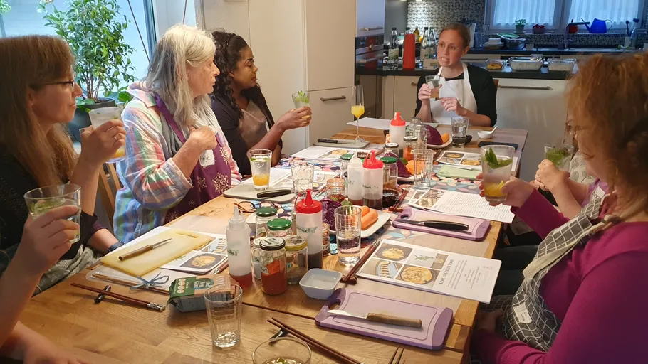Group in cooking class discussing recipes.
