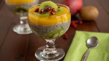 Chia pudding with mango, kiwi, and pomegranate garnish.