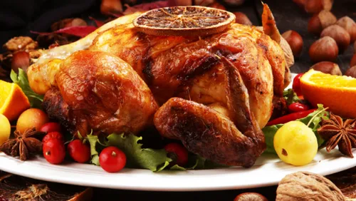 Roast chicken with fruits and nuts garnishing.