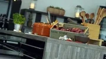 Kitchen counter with vegetables and utensils.