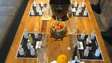 Table with bottles and snacks setup for tasting.