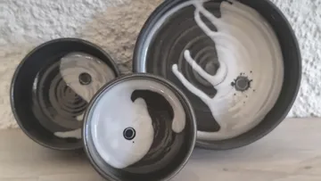 Three ceramic bowls with artistic black-and-white patterns.
